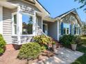 Inviting gray home with tidy landscaping, brick accents, and bright blue shutters at 4908 Birkenhead Ct, Apex, NC 27539