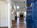 Inviting living room with vaulted ceilings, skylights, fireplace, and wood flooring at 4908 Birkenhead Ct, Apex, NC 27539