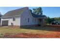 New home exterior with gray siding, rear deck and an unfinished lawn space at 499 Mulberry Rd, Spring Hope, NC 27882