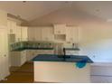 Bright open kitchen with white cabinets, granite counters, an island and modern fixtures at 499 Mulberry Rd, Spring Hope, NC 27882