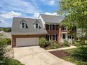 Charming two-story brick home with a two car garage, dormers, and professional landscaping at 5 Bobby Parker Pl, Durham, NC 27703