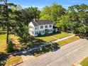 A picturesque aerial shot captures a classic two-story home nestled among mature trees and a well-manicured lawn at 506 S King Ave, Dunn, NC 28334