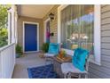 Inviting front porch featuring ample seating with plush pillows, a decorative rug, and a view of the charming neighborhood at 508 E Trinity Ave, Durham, NC 27701