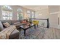 Bright living room featuring large arched windows, stylish furniture, and contemporary decor at 5420 Vista View Ct, Raleigh, NC 27612
