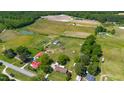 Lush aerial view featuring homes, green landscapes, and water features, showcasing a serene community surrounded by trees at 5423 Nc-39, Selma, NC 27576