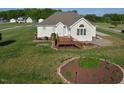 Exterior of home with rear deck, stone patio, and a well-manicured lawn at 55 Derwin Dr, Timberlake, NC 27583