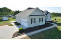 Exterior of home with an attached garage, manicured landscaping, and a paved driveway at 55 Derwin Dr, Timberlake, NC 27583