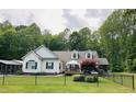 Charming home with white siding, green shutters, well-manicured lawn, and a fenced yard at 67 Bull Run N, Timberlake, NC 27583