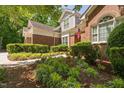 Beautiful home with brick and siding exterior surrounded by lush landscaping at 72103 Moseley, Chapel Hill, NC 27517