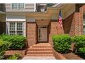 Inviting front entrance featuring brick steps, brick surround, and an American flag at 72103 Moseley, Chapel Hill, NC 27517
