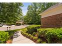 Well-maintained landscaping surrounding the house with greenery and a sidewalk at 72103 Moseley, Chapel Hill, NC 27517