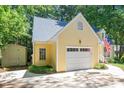 Side view of the house showing the garage, driveway, and a storage building at 829 Joyner Ct, Wake Forest, NC 27587