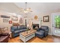 Cozy living room with hardwood floors, fireplace, ceiling fan, and comfortable seating at 829 Joyner Ct, Wake Forest, NC 27587