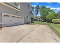 Spacious driveway leading to a two-car garage and a well-maintained backyard at 1012 Wandering Way, Rolesville, NC 27571