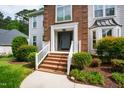 Beautiful home with brick front, manicured landscaping, and welcoming entrance at 103 Tremont Cir, Chapel Hill, NC 27516