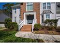 Inviting home featuring brick facade, a welcoming entrance, and well-maintained landscaping at 103 Tremont Cir, Chapel Hill, NC 27516