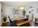 Elegant dining room with a modern light fixture, stylish decor, and ample seating for gatherings at 106 Mesquite Dr, Durham, NC 27703
