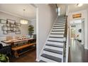 Inviting hallway with a staircase and dining room view, showcasing the home's layout and design at 106 Mesquite Dr, Durham, NC 27703