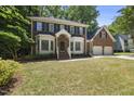 Traditional brick home featuring a well-kept lawn and attached two-car garage at 108 Westport Dr, Cary, NC 27511