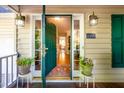 Open front door revealing the interior hallway with a hardwood floor and green accents at 1166 Nc Highway 87 N, Pittsboro, NC 27312