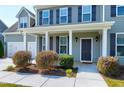 Inviting front porch with classic white columns, providing a welcoming entrance to the home at 120 Shore Pine Dr, Youngsville, NC 27596