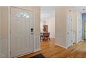 Welcoming entryway with hardwood floors leads to the dining room, showcasing the home's open layout at 1208 Copper Creek Dr, Durham, NC 27713