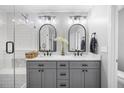 Elegant bathroom featuring double sinks, modern fixtures, and a separate glass-enclosed shower at 121 Talley Ridge Dr, Holly Springs, NC 27540