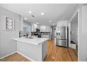 Spacious kitchen with stainless steel appliances, a breakfast bar, and ample counter space at 121 Talley Ridge Dr, Holly Springs, NC 27540