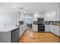 Bright, updated kitchen with stainless steel appliances, white cabinetry and hardwood floors at 121 Talley Ridge Dr, Holly Springs, NC 27540