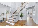 Grand foyer features hardwood floors, stairs with wood railing, white trim and shiplap walls at 1241 Keith Rd, Wake Forest, NC 27587