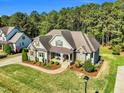 An aerial view of a two-story home with a well-maintained lawn and mature trees at 128 Paraggi Ct, Clayton, NC 27527
