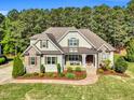 Beautiful front view of a two-story home boasting a lush green lawn and manicured landscaping at 128 Paraggi Ct, Clayton, NC 27527