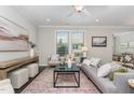 Bright living room with stylish decor, large windows, and hardwood floors throughout at 1314 Catch Fly Ln, Durham, NC 27713