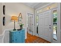 Bright foyer featuring hardwood floors, white wainscoting, and a charming accent table at 1401 Marshall Farm St, Wake Forest, NC 27587