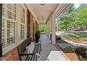 Long covered front porch with benches and classic white columns offers a welcoming space at 1401 Marshall Farm St, Wake Forest, NC 27587