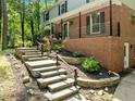 The home's entry features stone stairs leading to a covered porch with brick columns at 1509 Cumberland Rd, Chapel Hill, NC 27514