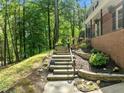 Beautiful stone steps ascend toward the home's entryway, surrounded by lush greenery at 1509 Cumberland Rd, Chapel Hill, NC 27514