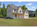 Attractive two-story home with a two-car garage and a covered front porch, set on a large grassy lot at 1605 Sassafras St, Durham, NC 27712