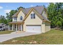 Inviting two-story home with a spacious two-car garage, a covered porch, and a well-maintained lawn at 1605 Sassafras St, Durham, NC 27712