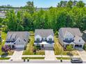 Scenic aerial view of a home in a residential neighborhood, surrounded by lush trees and well-manicured lawns at 1709 Chestnut Falls Rd, Wendell, NC 27591