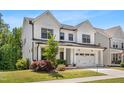 Stylish two-story home with a white exterior, complemented by well-maintained landscaping and a welcoming front porch at 1709 Chestnut Falls Rd, Wendell, NC 27591