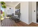 Inviting front porch with rocking chairs and hanging plants, perfect for relaxing and enjoying the outdoors at 1709 Chestnut Falls Rd, Wendell, NC 27591