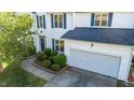 Beautiful two-story home featuring a two-car garage, landscaped yard and a brick walkway at 1909 Redding Lane, Durham, NC 27712