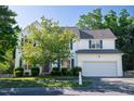 Attractive two-story white home with manicured lawn and blue shutters at 1909 Redding Lane, Durham, NC 27712