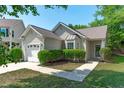 Charming home with landscaped front yard, attached garage, and inviting entrance, perfect for suburban living at 20 Keswick Ct, Durham, NC 27713