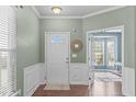 Inviting foyer with wood floors, decorative wall trim, and a view into the bright and airy living spaces at 20 Keswick Ct, Durham, NC 27713