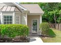 Welcoming home entrance with a classic door, lush landscaping, and a neatly paved walkway at 20 Keswick Ct, Durham, NC 27713