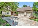 Traditional home with a three-car garage, mature landscaping, and a well-manicured lawn at 20011 Bragg, Chapel Hill, NC 27517