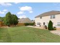 A well-maintained backyard with lush lawn, fire pit, and a charming patio area perfect for outdoor gatherings at 203 Green Pasture Rd, Mebane, NC 27302