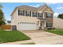 Two-story home features a manicured lawn, two-car garage, and stone and siding accents at 203 Green Pasture Rd, Mebane, NC 27302